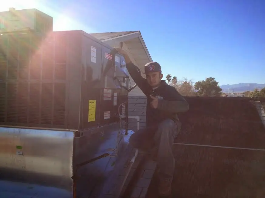 HVAC technician performing HVAC Inspection on a rooftop unit in Wade Hampton